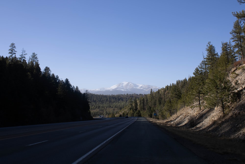 a road with a mountain in the distance