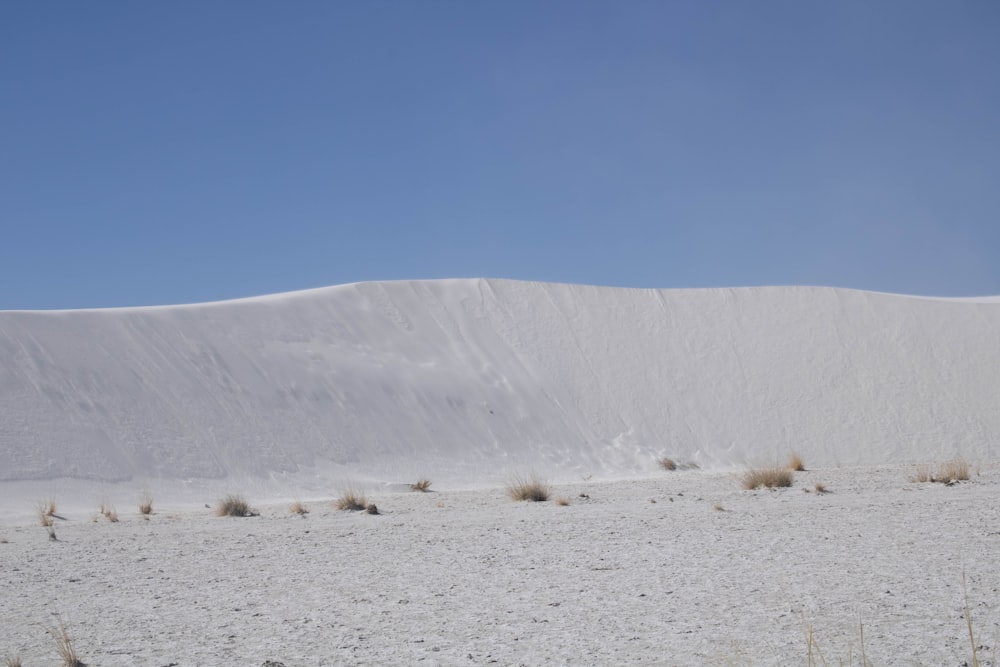 a large white sand dune in the middle of a desert