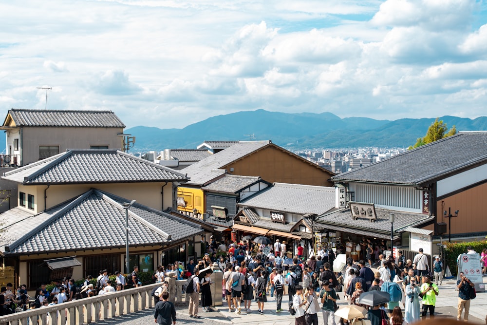 a crowd of people walking around a city