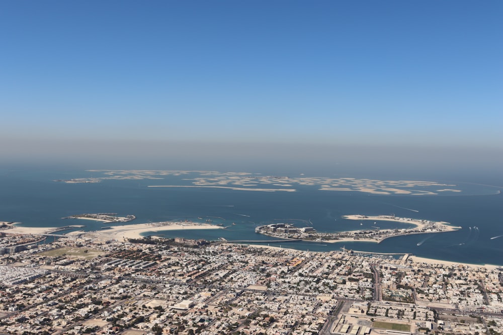 an aerial view of a city and a body of water