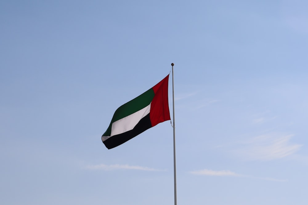 a flag flying in the wind on a pole