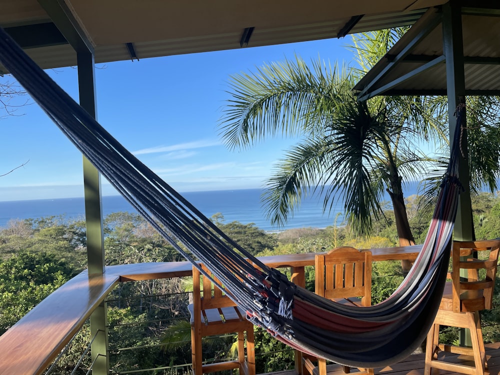 a hammock on a porch overlooking the ocean