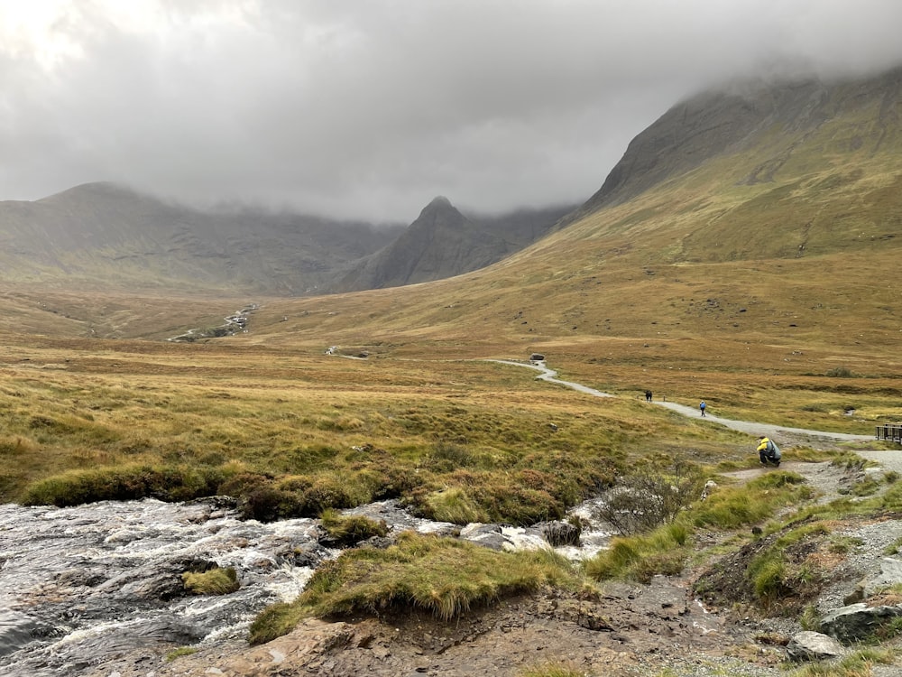 a car driving down a road in the mountains