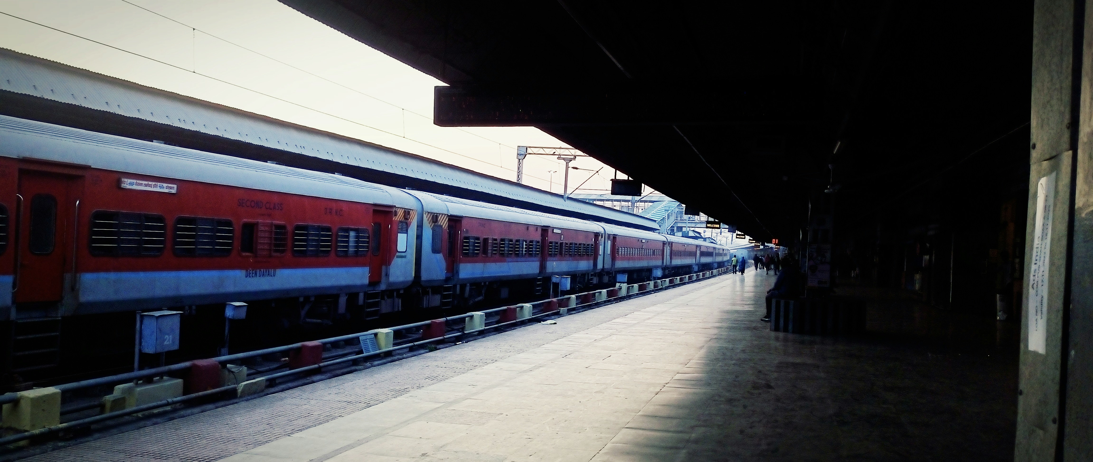 a red and blue train is at a train station