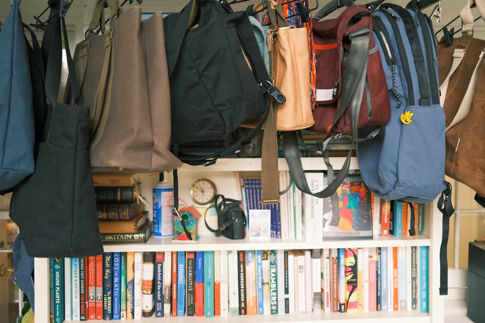 a book shelf filled with lots of books and bags