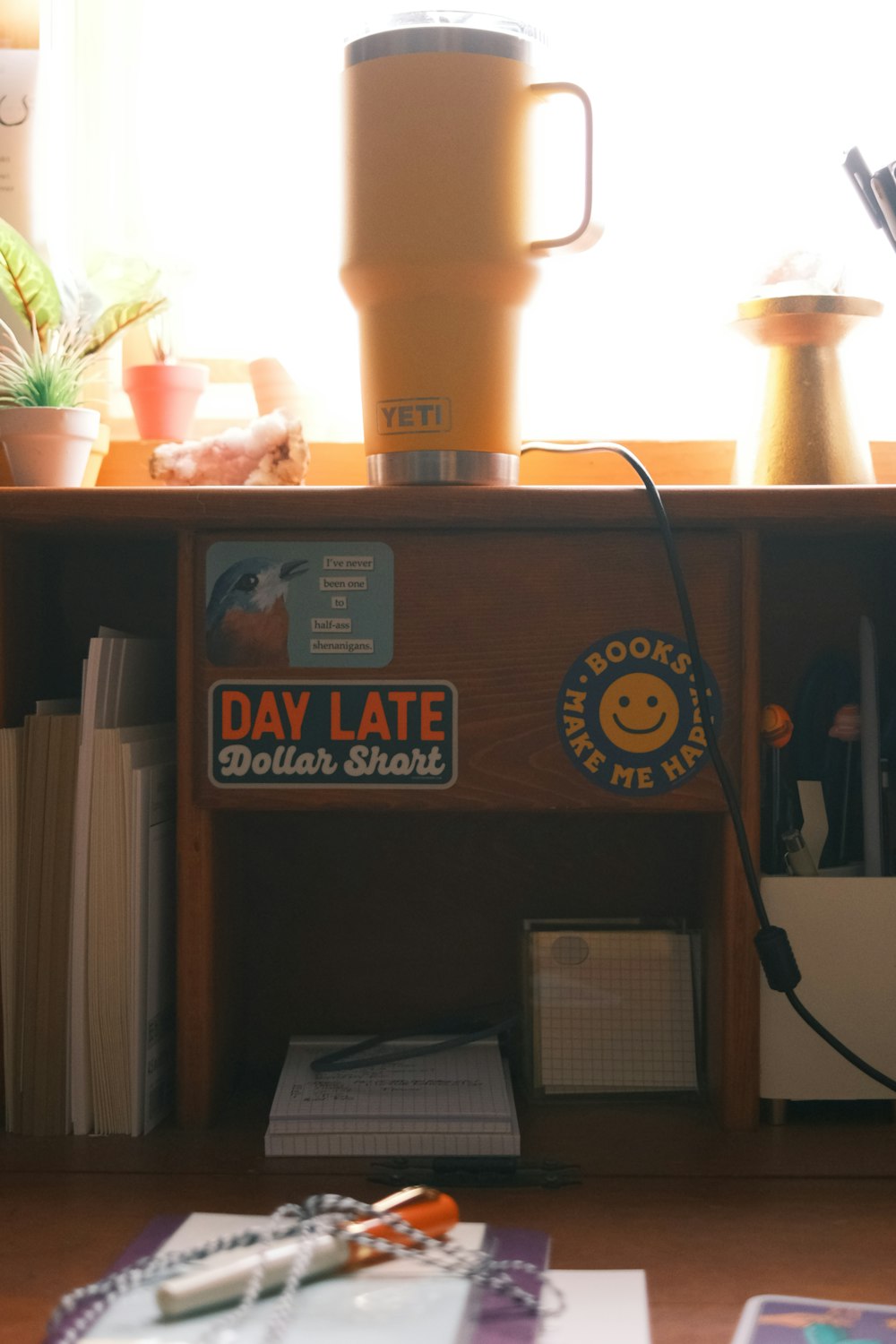 a desk with a coffee pot and a blender on top of it