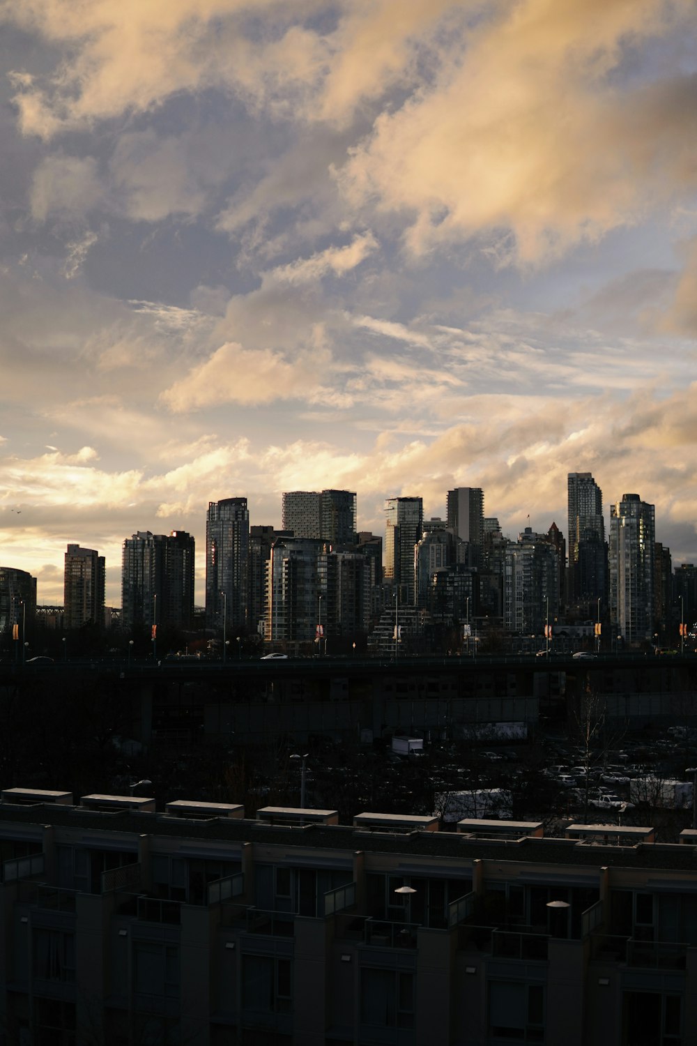 a view of a city skyline with a bridge in the foreground