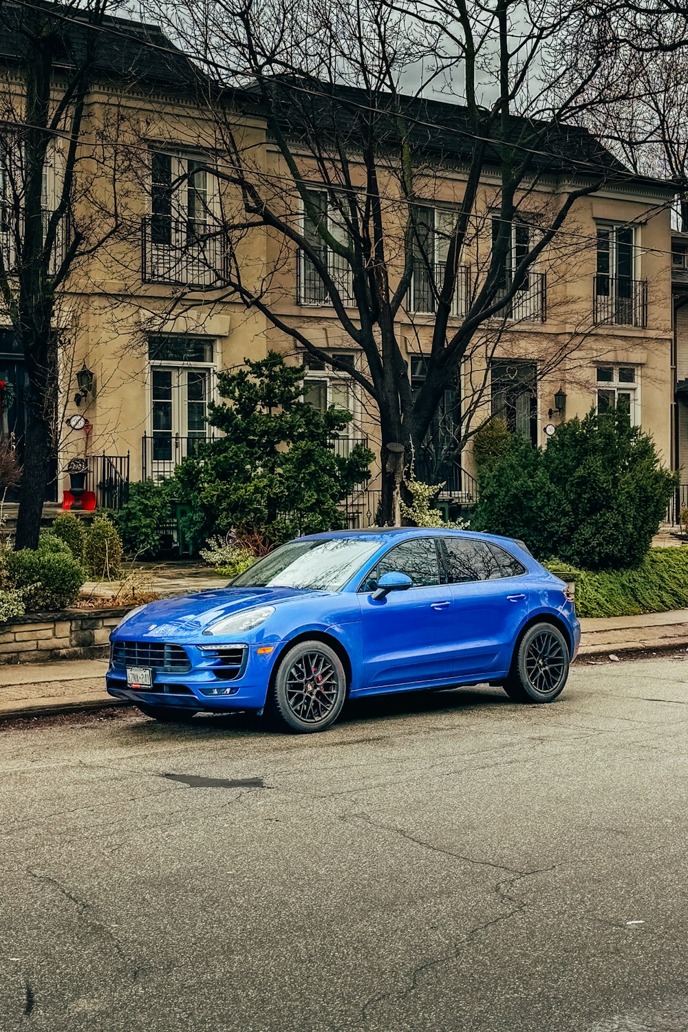 a blue car parked on the side of the road