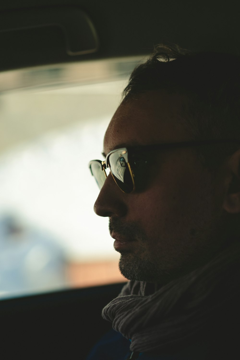 a man wearing sunglasses sitting in a car