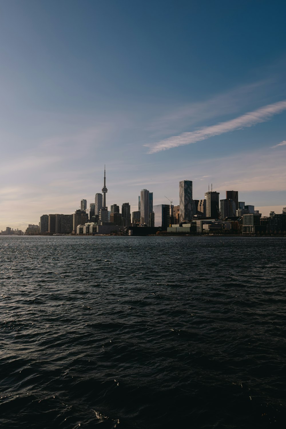 a large body of water with a city in the background