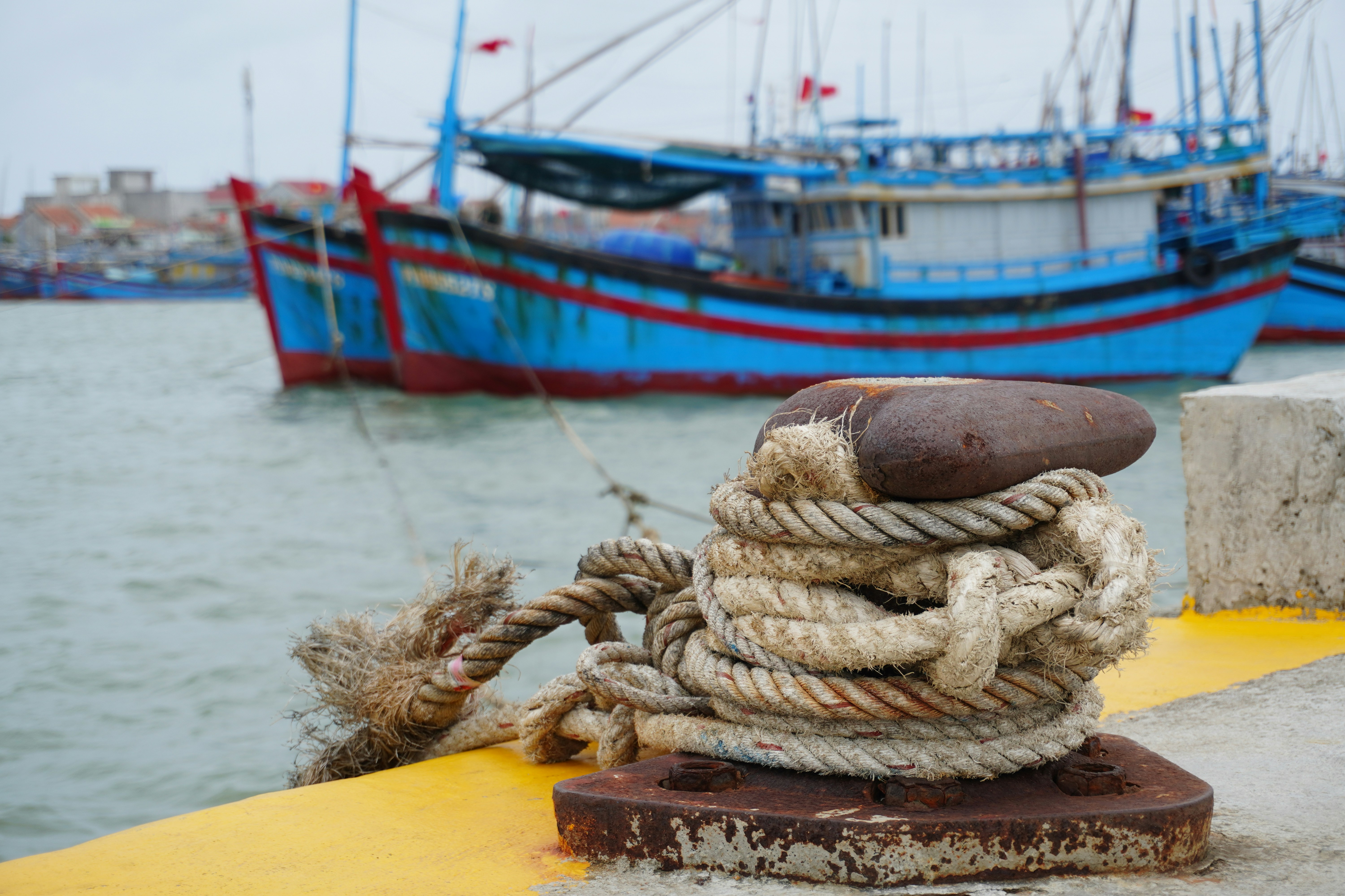 a pile of rope sitting on top of a yellow dock