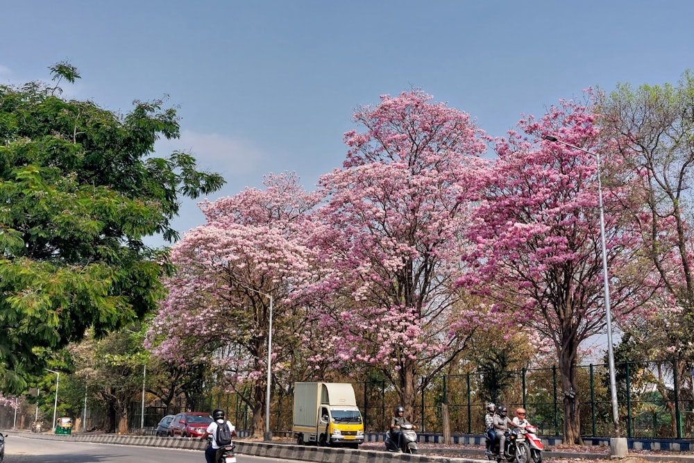 a group of people riding motorcycles down a street