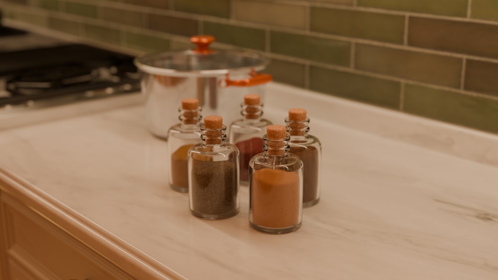 a kitchen counter topped with bottles filled with spices