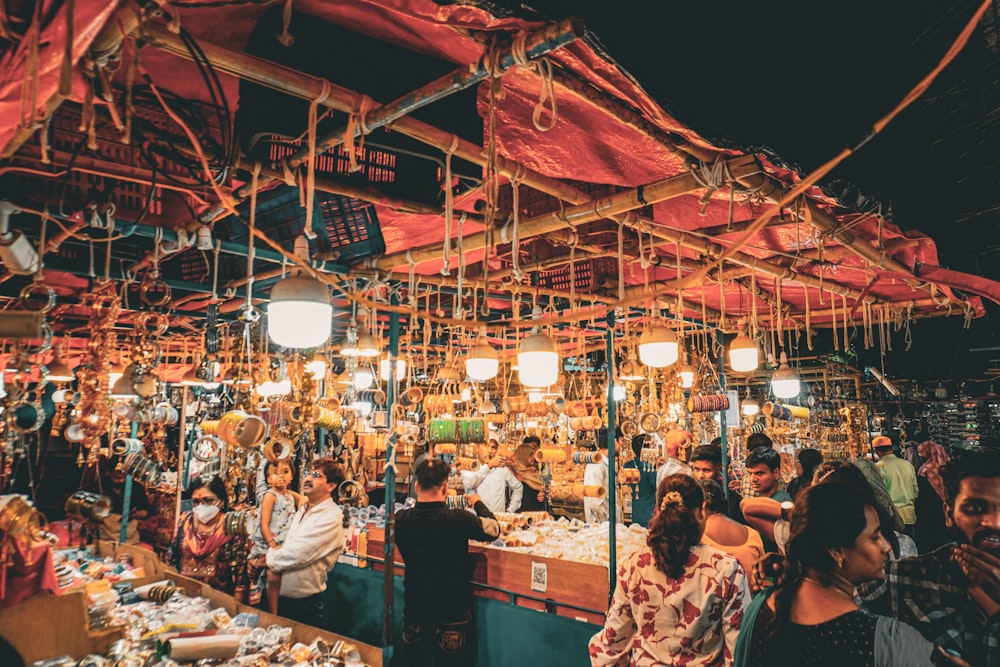 a group of people standing around a market