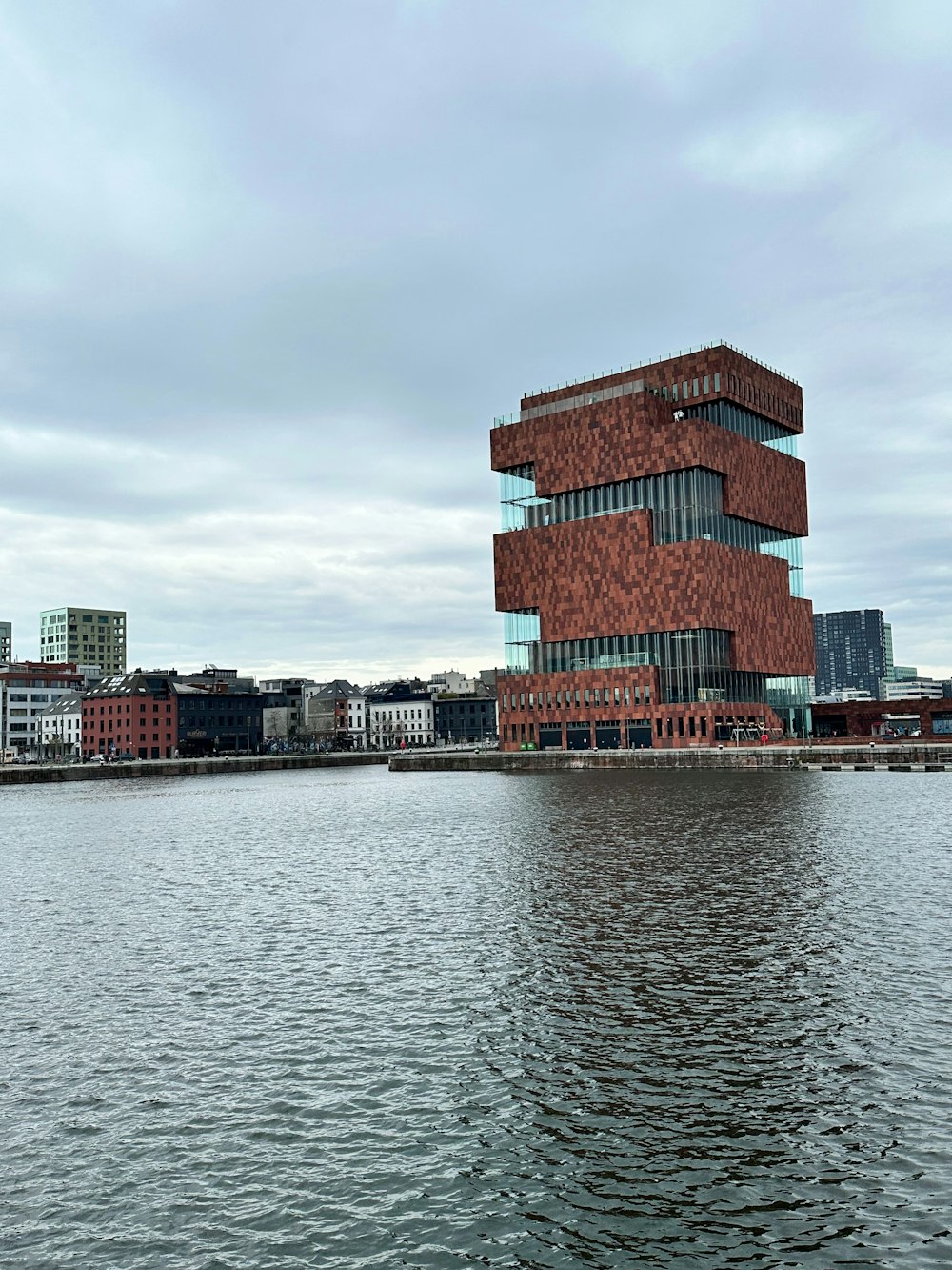 a large body of water next to a tall building