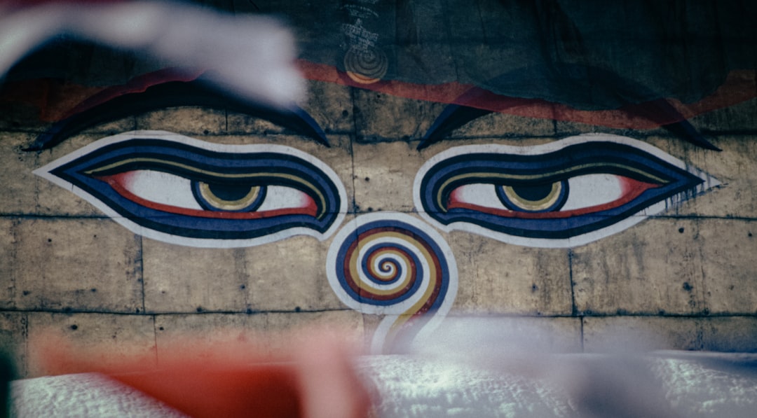 This image captures the iconic 'Eyes of Buddha,' a symbolic element found on the stupas of Nepal, representing the all-seeing ability of the Buddha. These eyes of wisdom, often accompanied by the 'third eye' symbolizing enlightenment, reflect the rich spiritual heritage of Kathmandu.