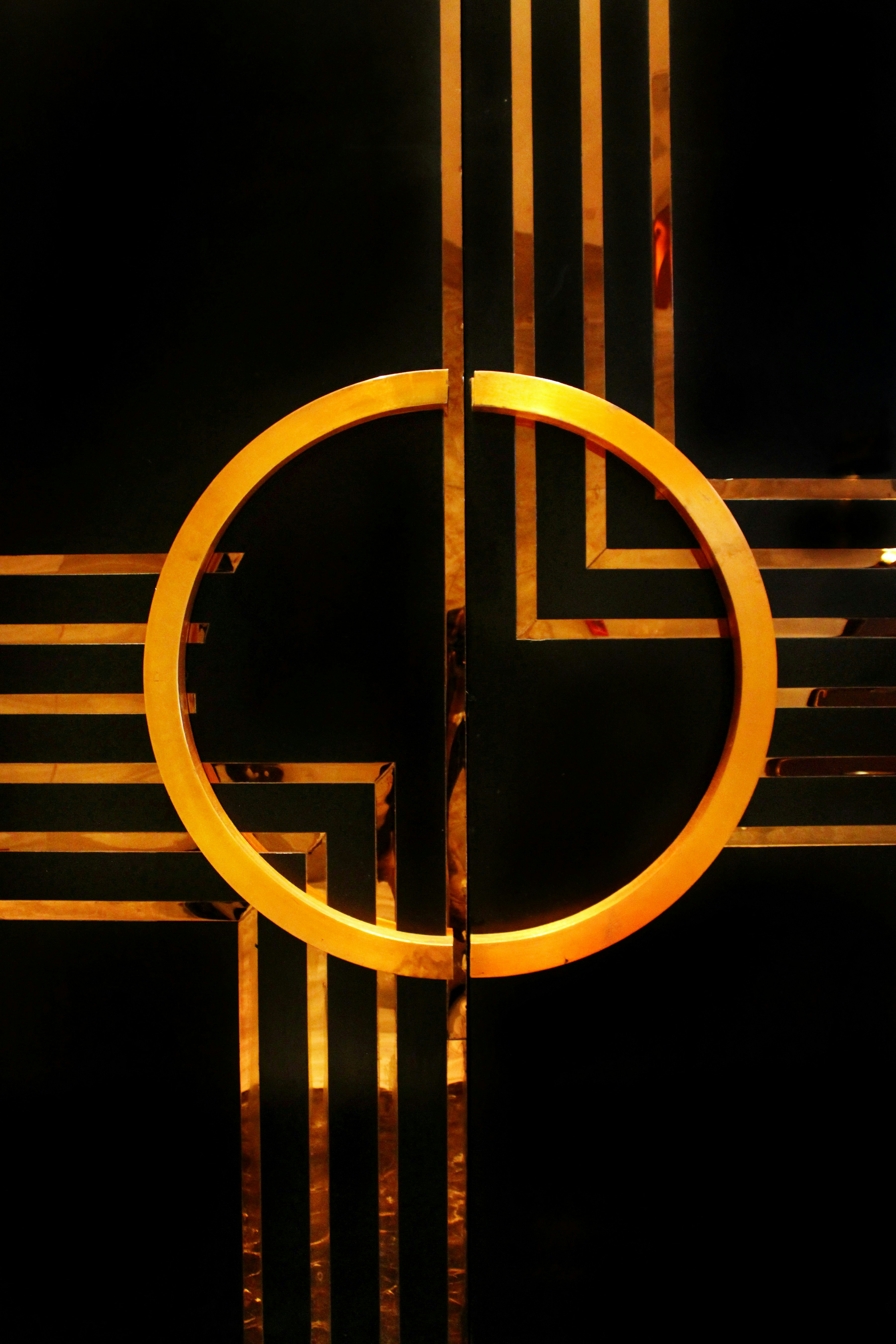 a black and gold wall with a circular design
