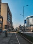 an empty street in a city with tall buildings