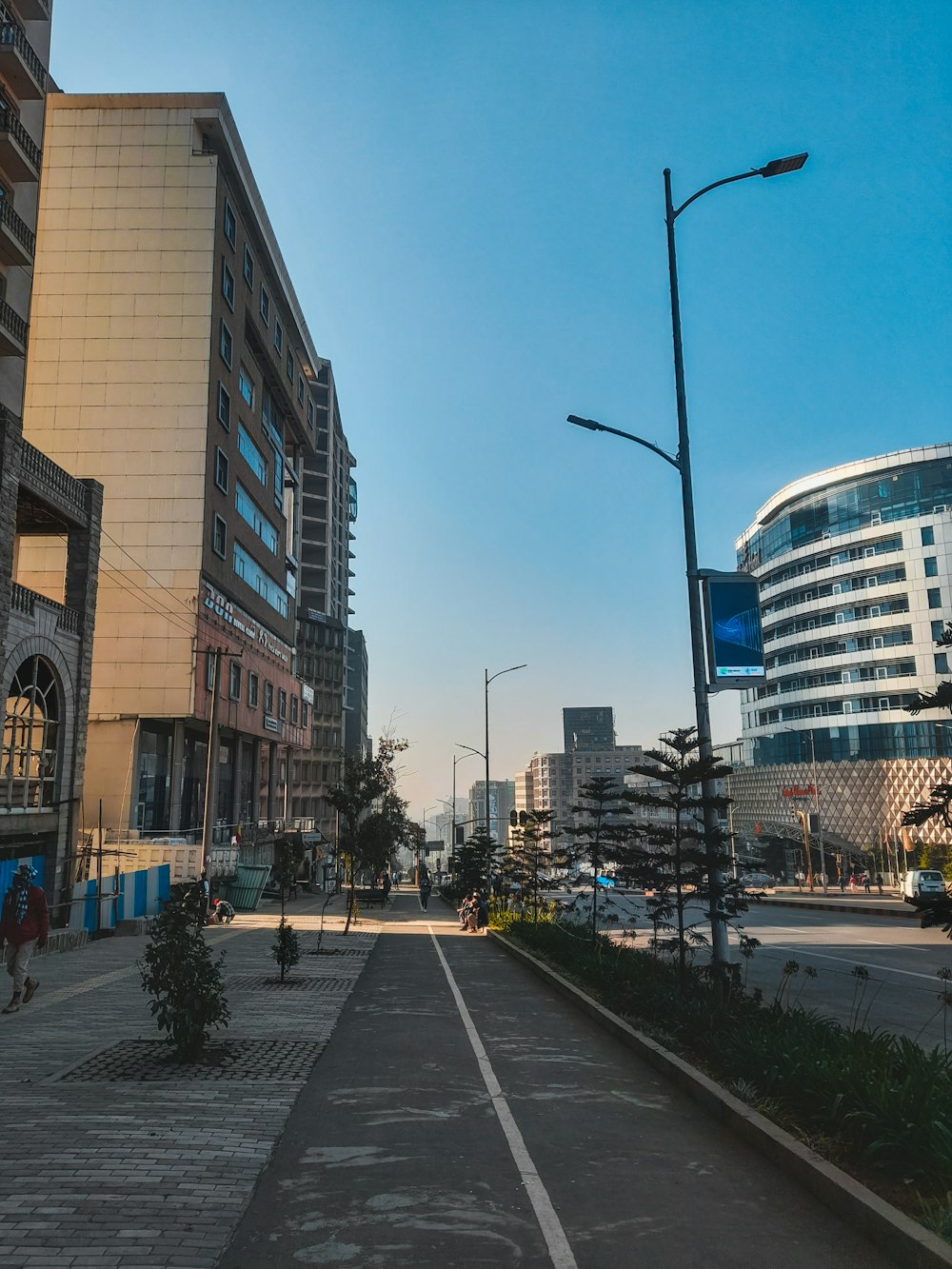 an empty street in a city with tall buildings