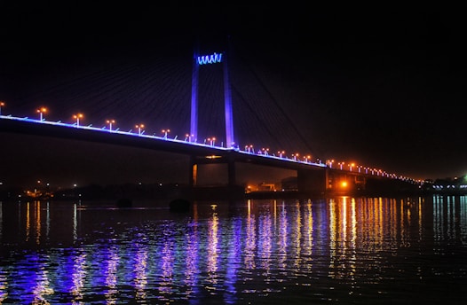 a large bridge over a body of water at night