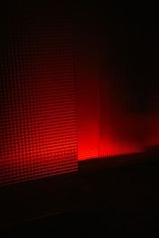 a red light is shining on a wall