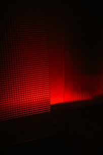 a red light is shining on a wall