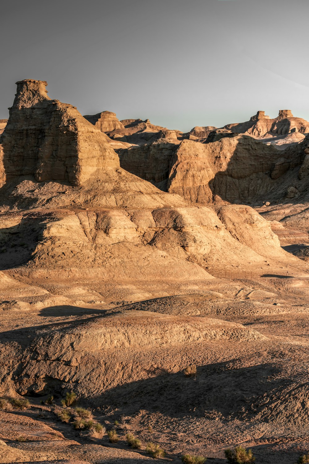 a rocky landscape with a mountain range in the background