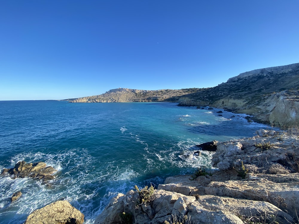 a body of water surrounded by rocky coastline