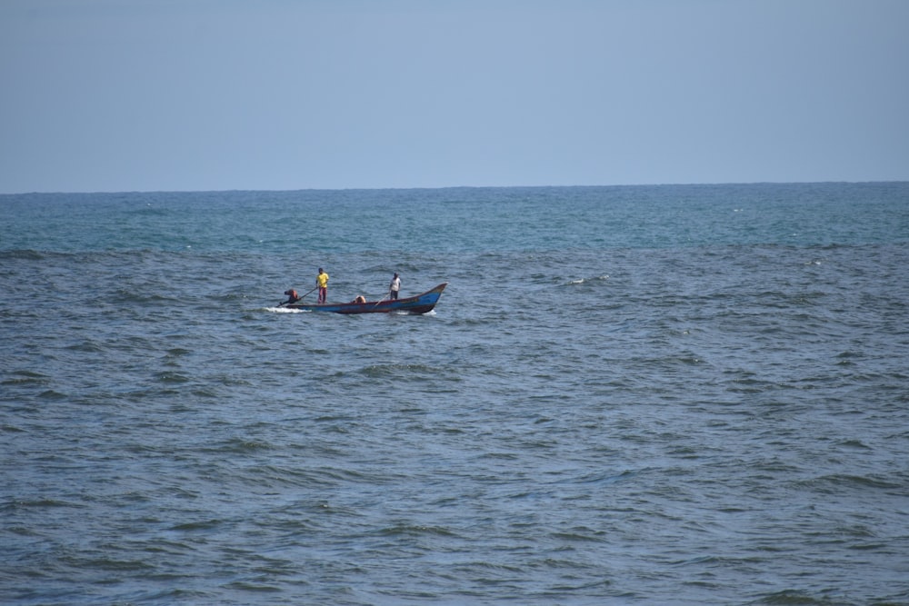 two people in a small boat in the middle of the ocean