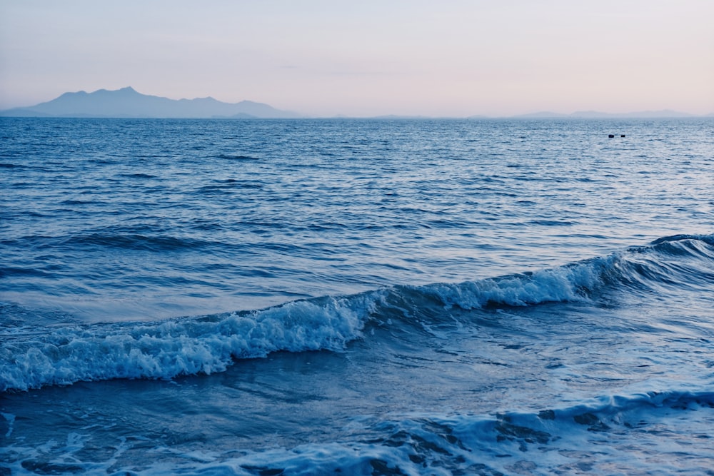 a large body of water with a small island in the distance