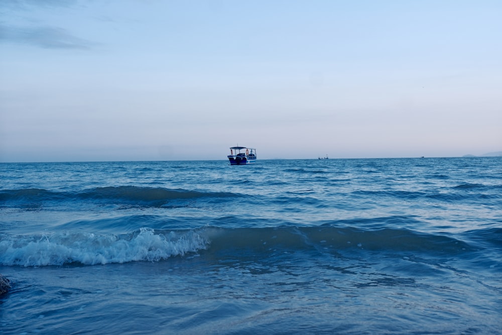 a small boat in the middle of the ocean