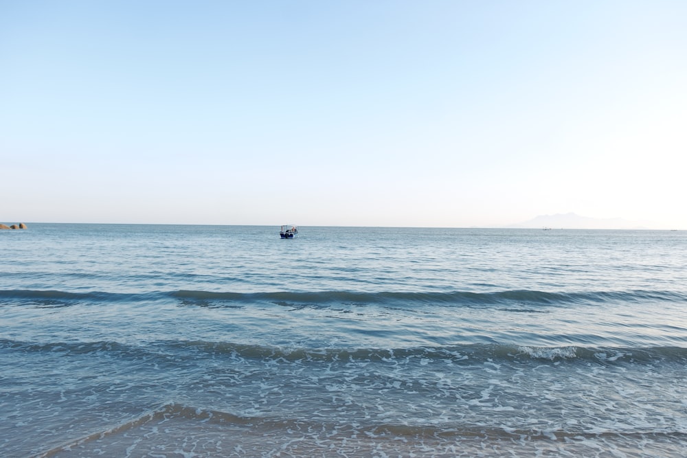 a boat is out in the ocean on a sunny day