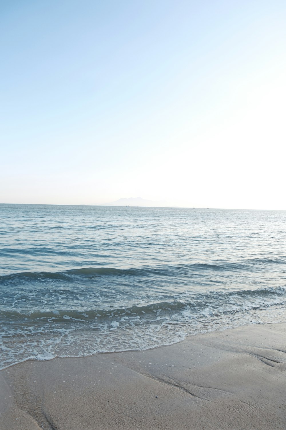 a surfboard sitting on top of a sandy beach