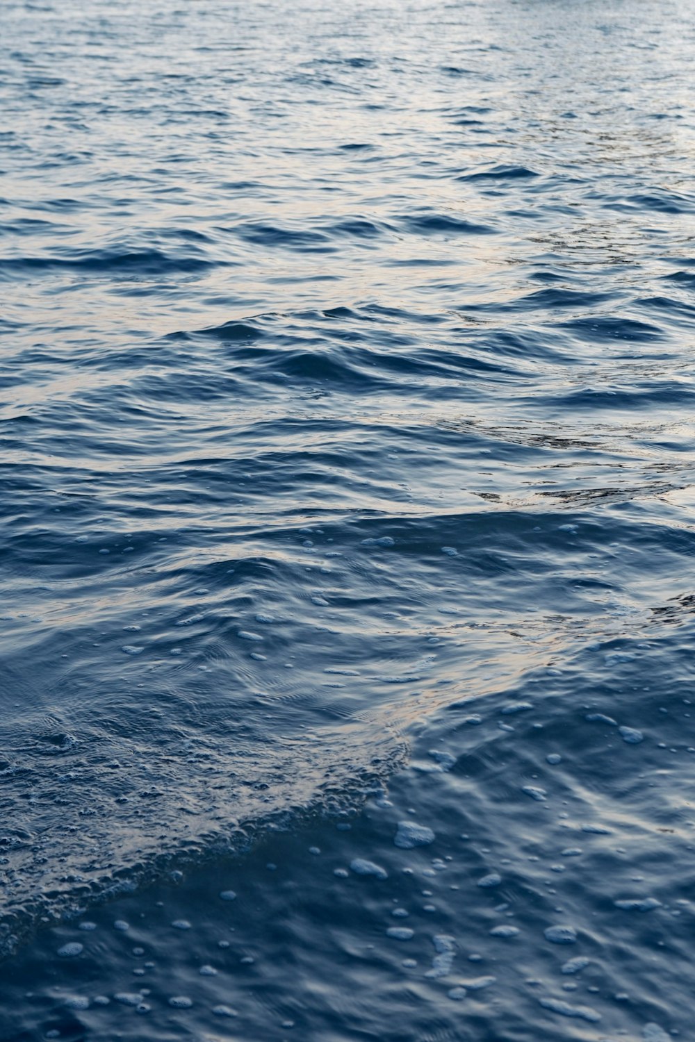 a man riding a surfboard on top of a wave in the ocean