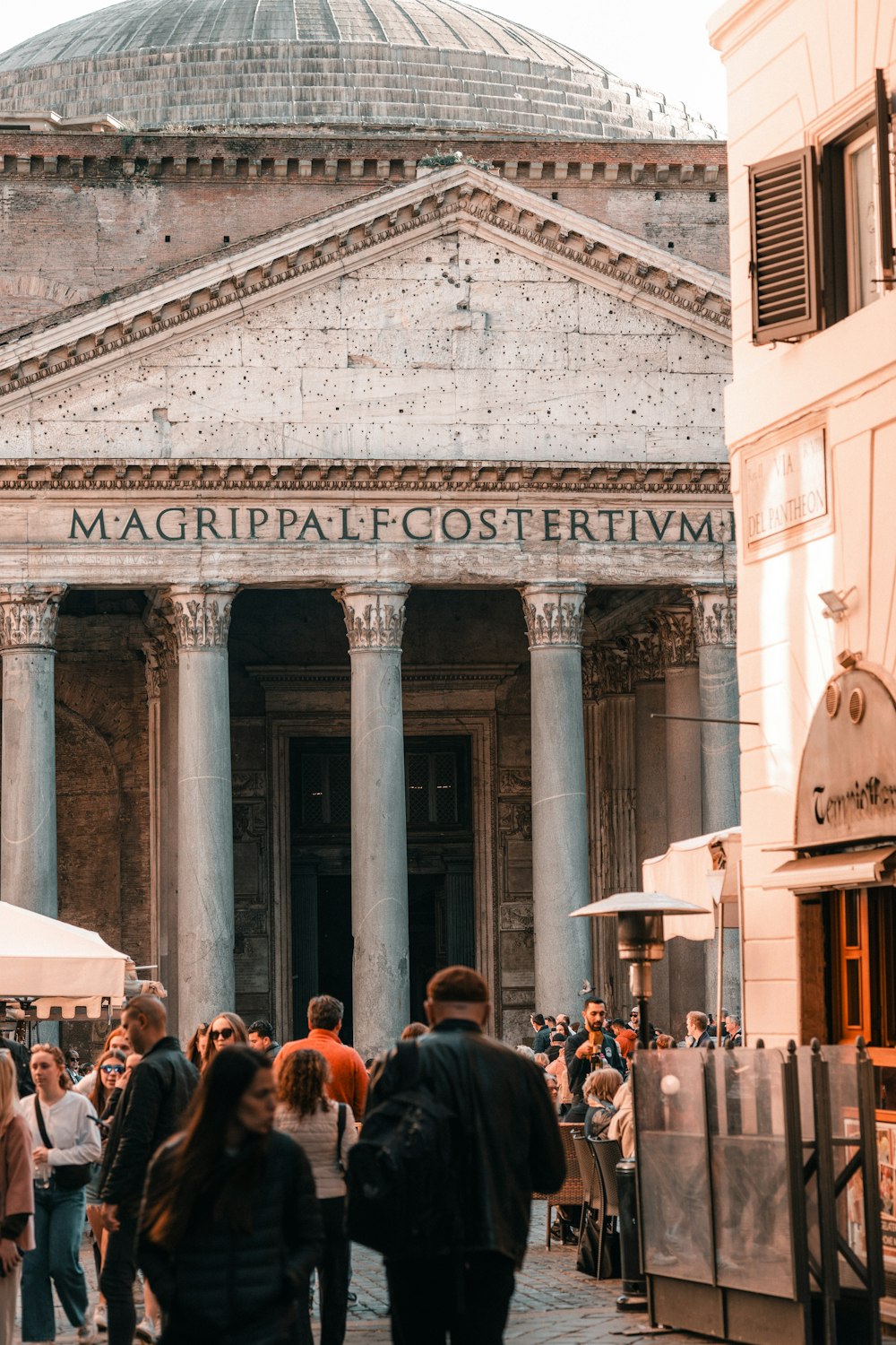 a group of people walking in front of a building