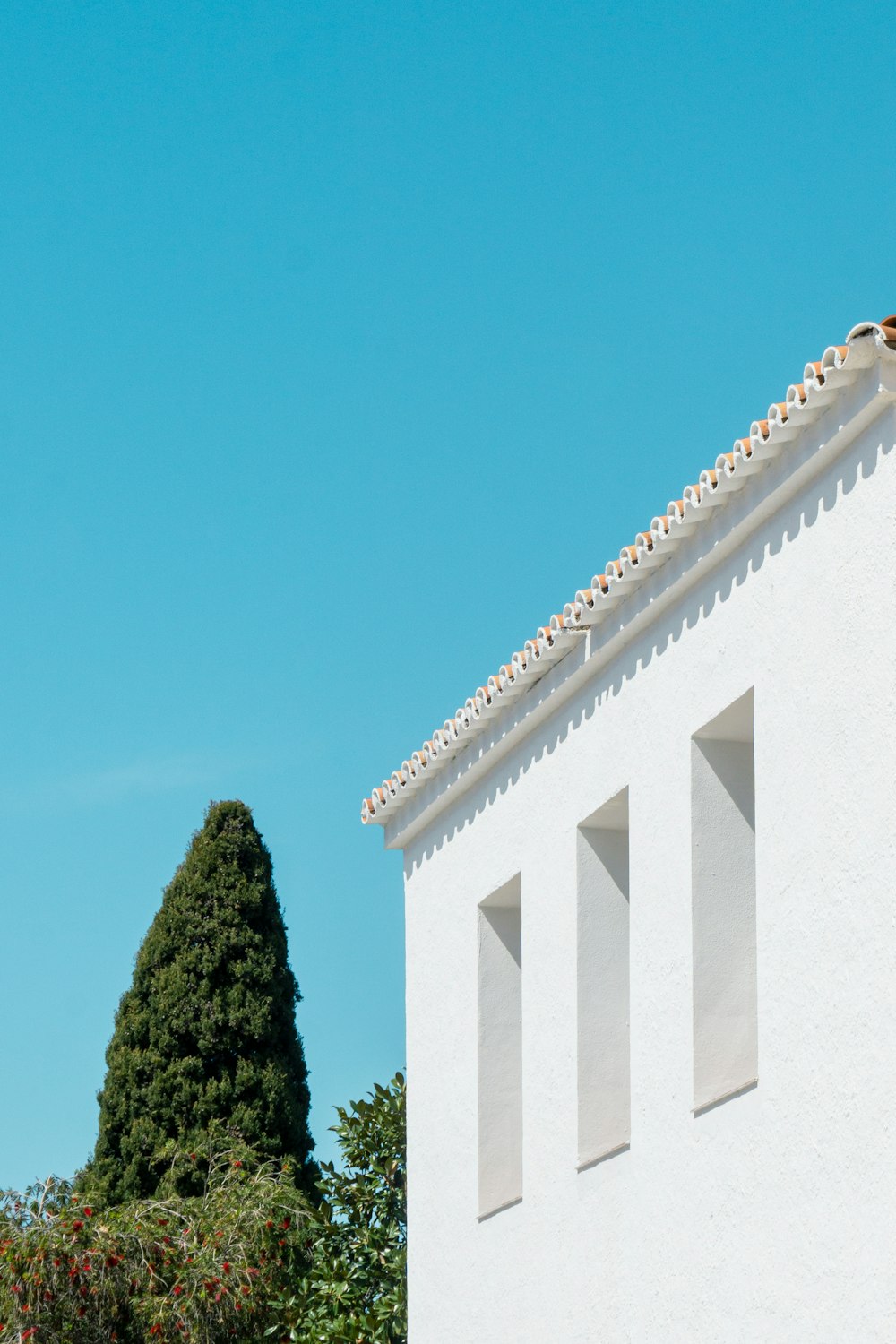 a white building with a clock on the top of it