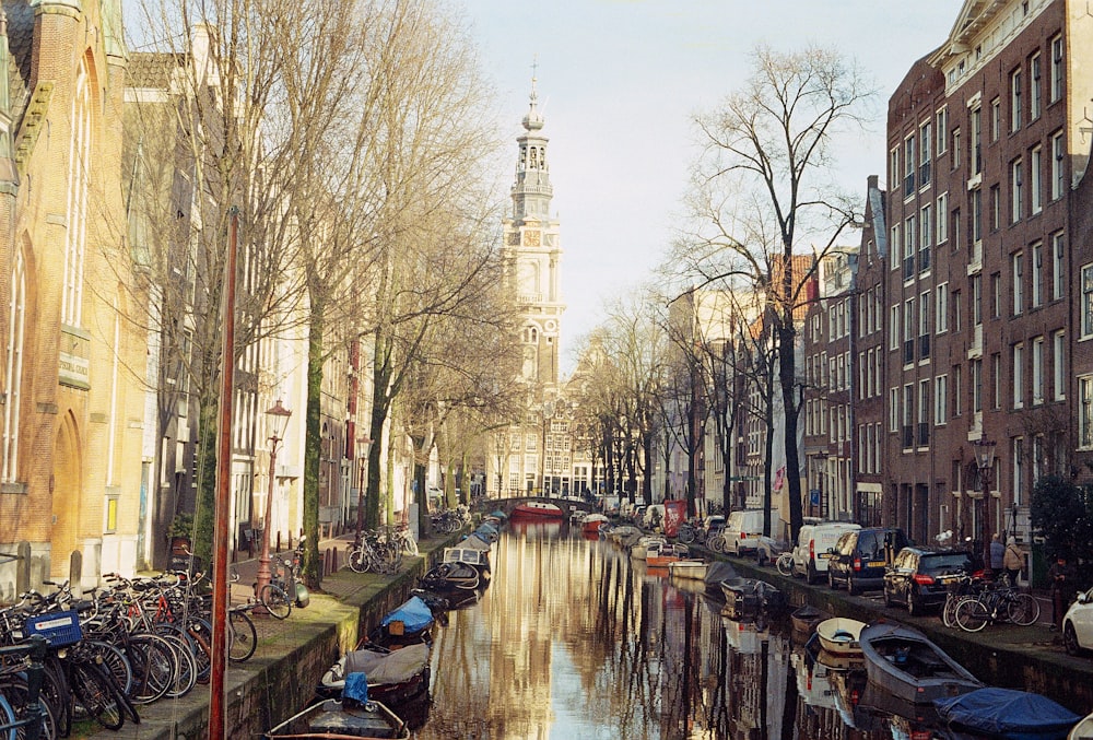 a narrow canal with boats and bicycles parked along the side of it