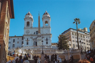 a group of people walking up and down stairs in front of a church
