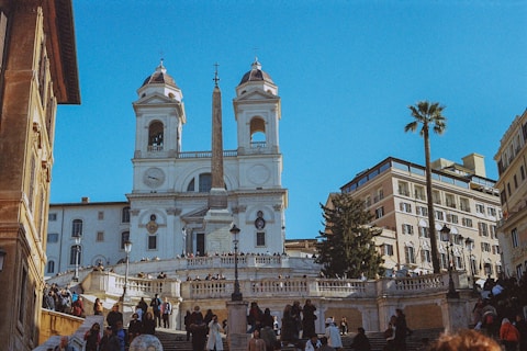 a group of people walking up and down stairs in front of a church