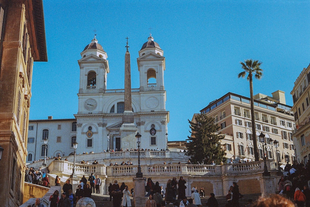 a group of people walking up and down stairs in front of a church