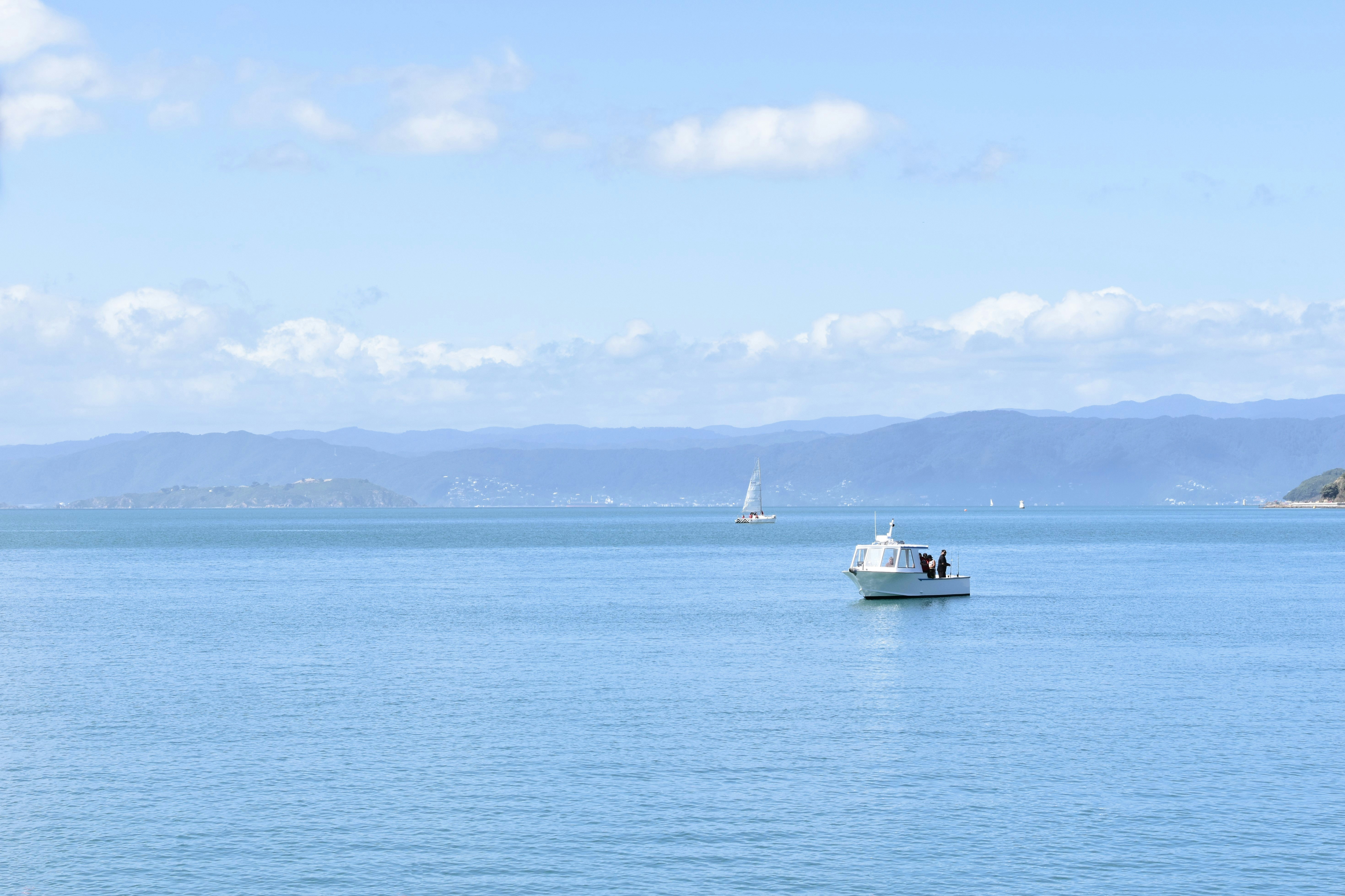 a small boat floating on top of a large body of water