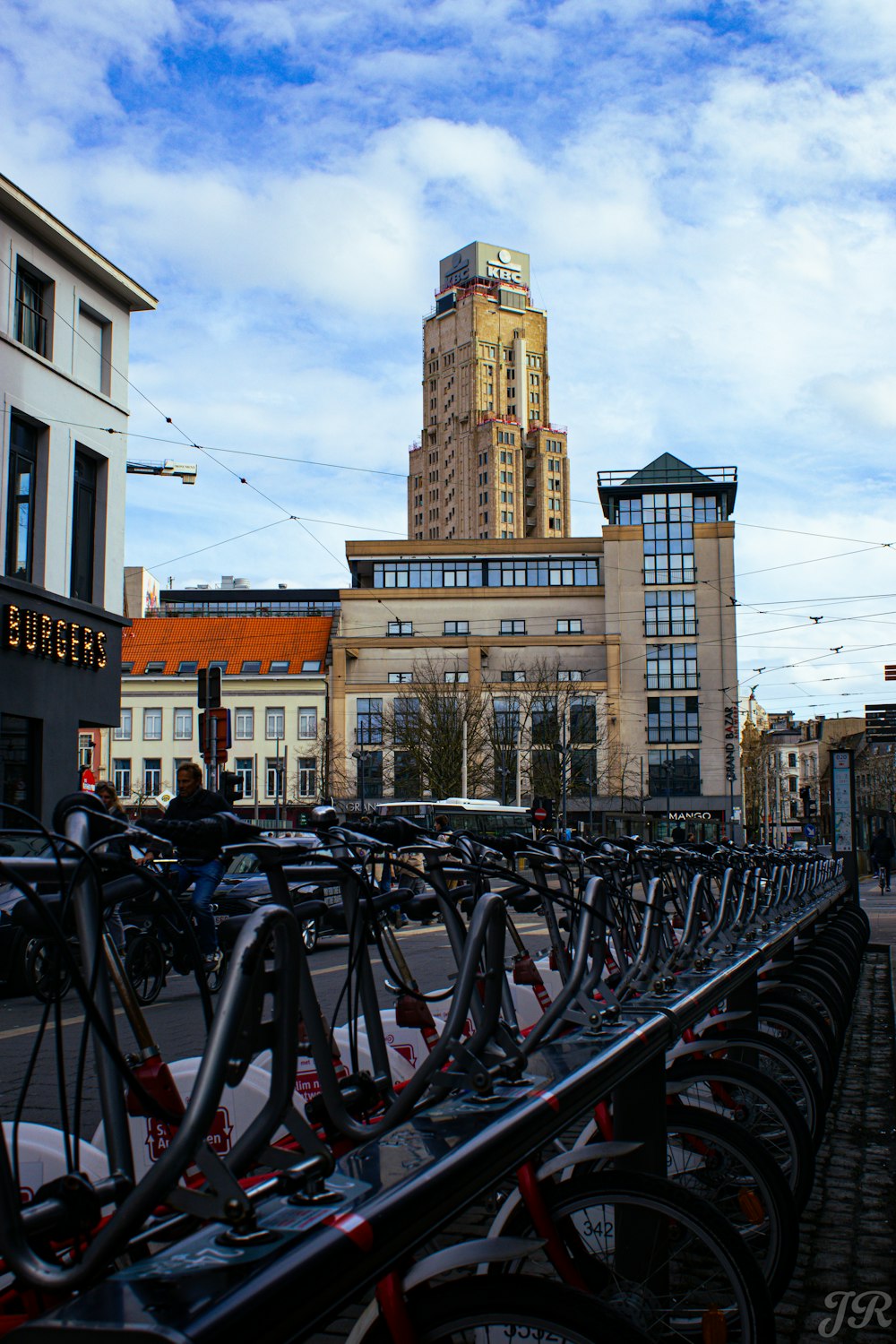 a row of bikes parked next to each other on a sidewalk