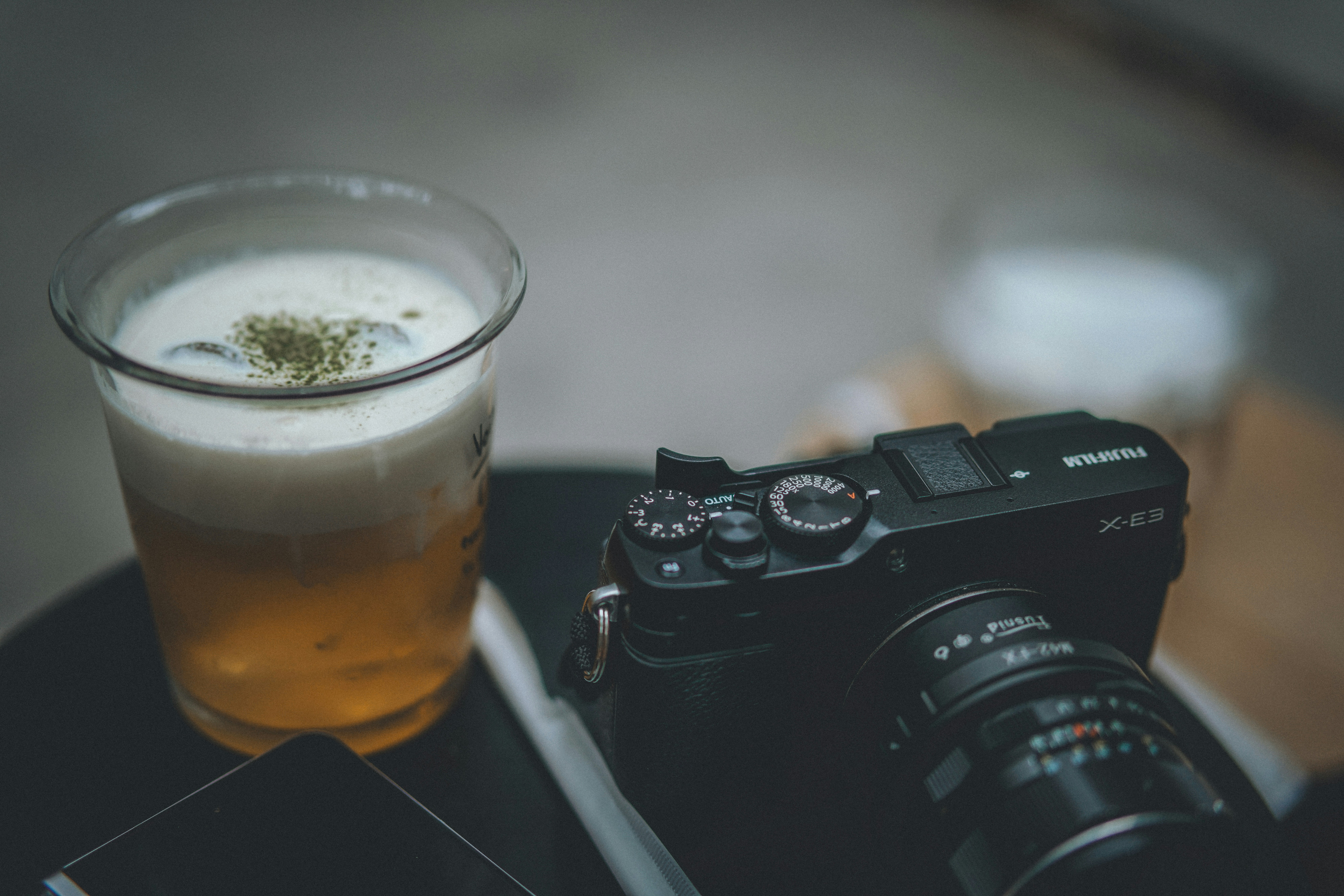 a camera and a glass of beer on a table
