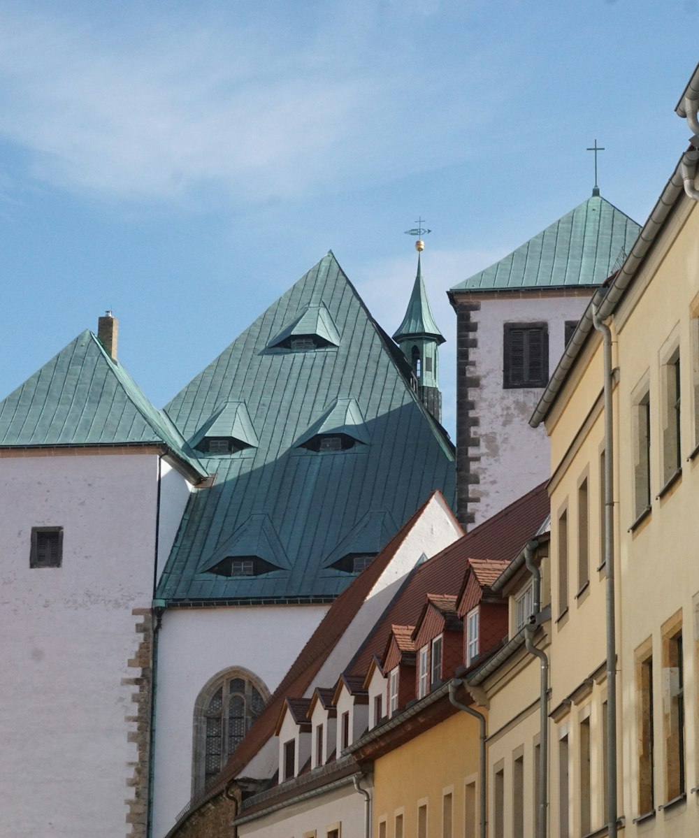 a row of buildings with a clock tower in the background