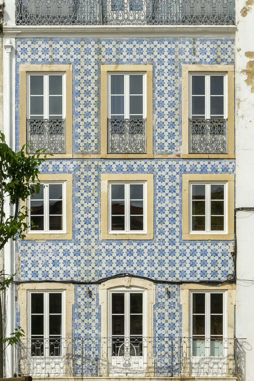 a blue and white building with windows and balconies