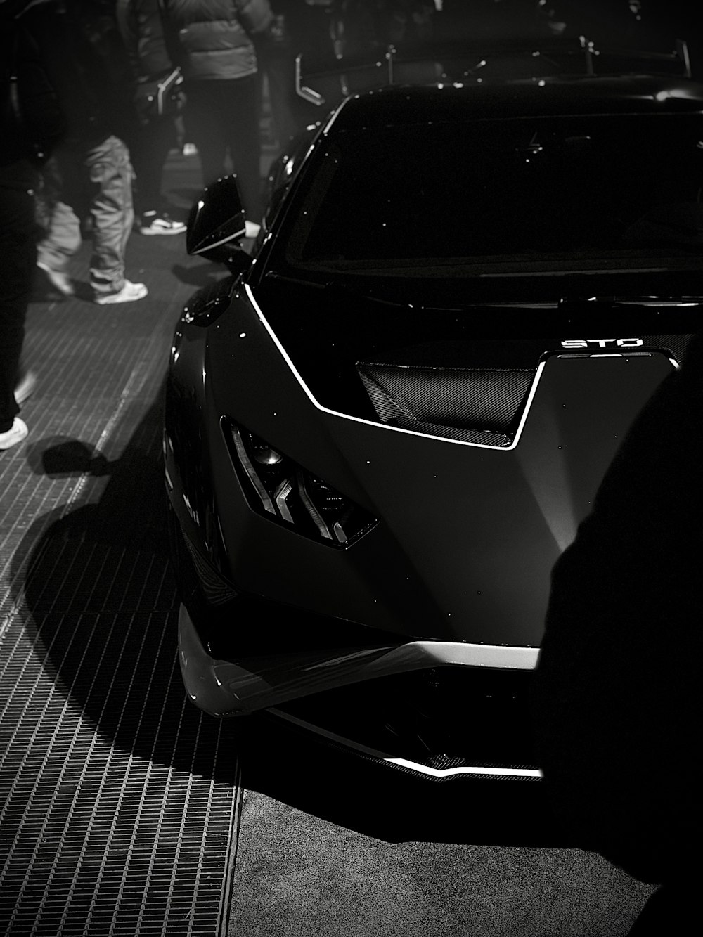 a black and white photo of a sports car