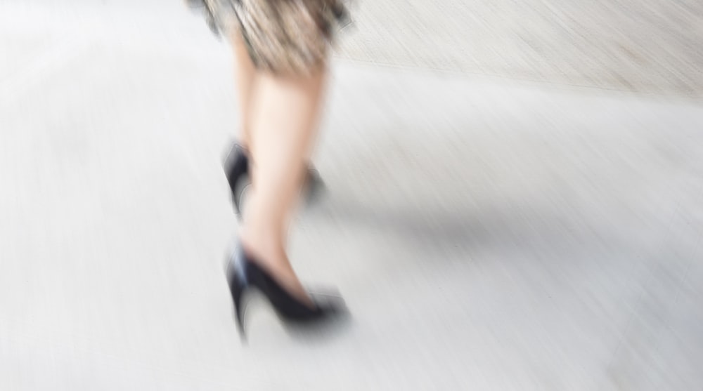 a blurry photo of a woman's legs in high heels