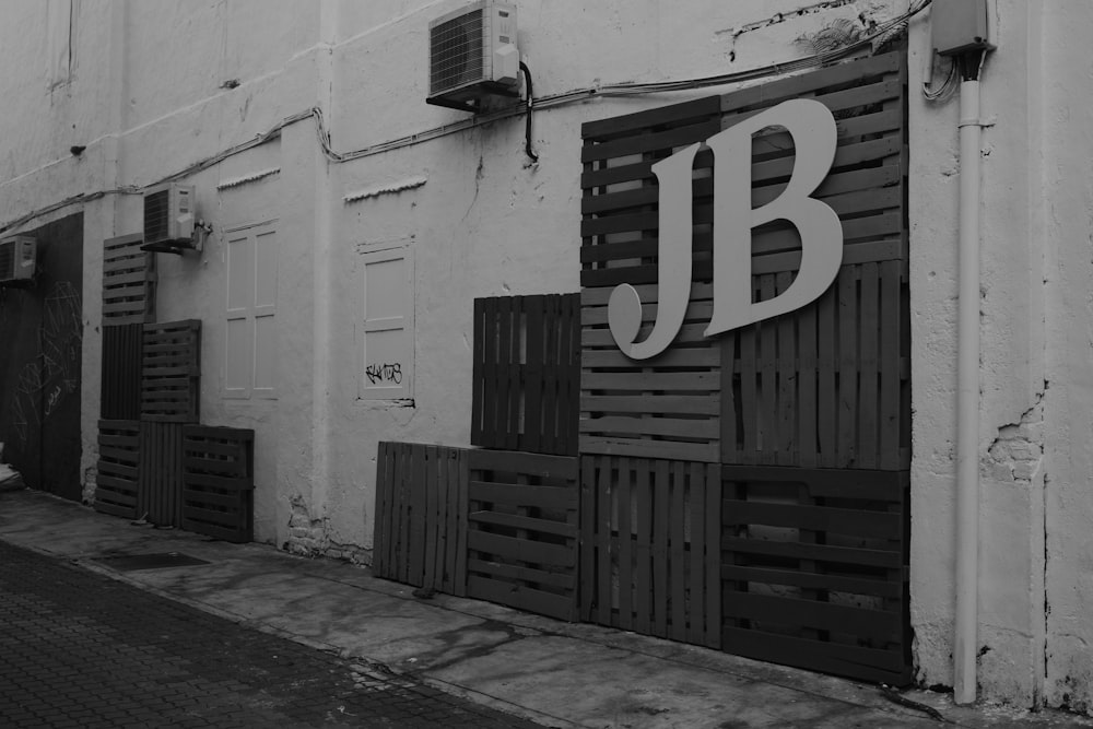 a black and white photo of a building with a jb sign on it