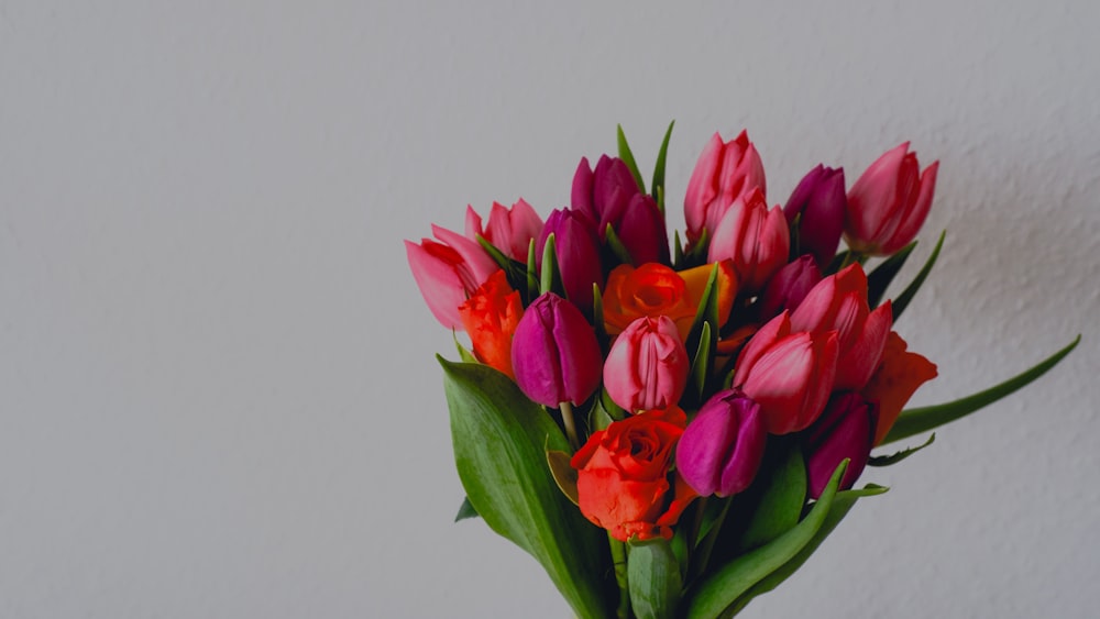 a bouquet of tulips in a vase on a table