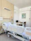a hospital room with two beds and a desk